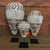 TKN063 SET OF THREE BLACK WASH WOODEN TRIBAL UNE MASK ON STAND DECORATIONS